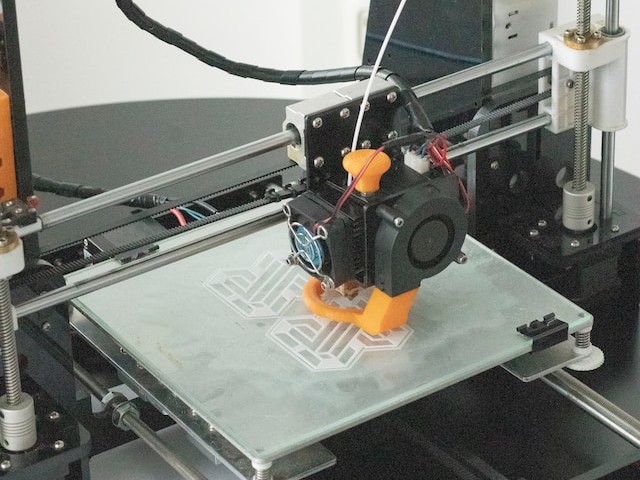 A 3D printer printing a small object on top