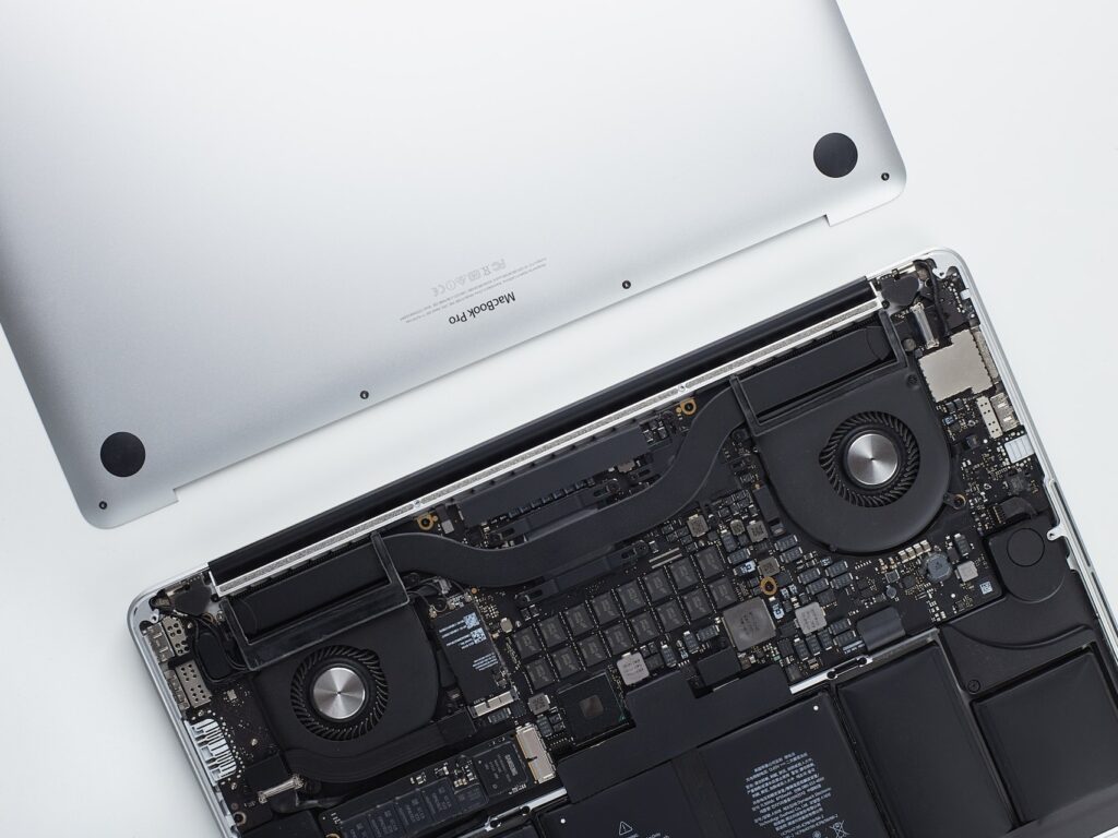 An image of an Apple MacBook Pro undergoing computer repair due to a broken motherboard.